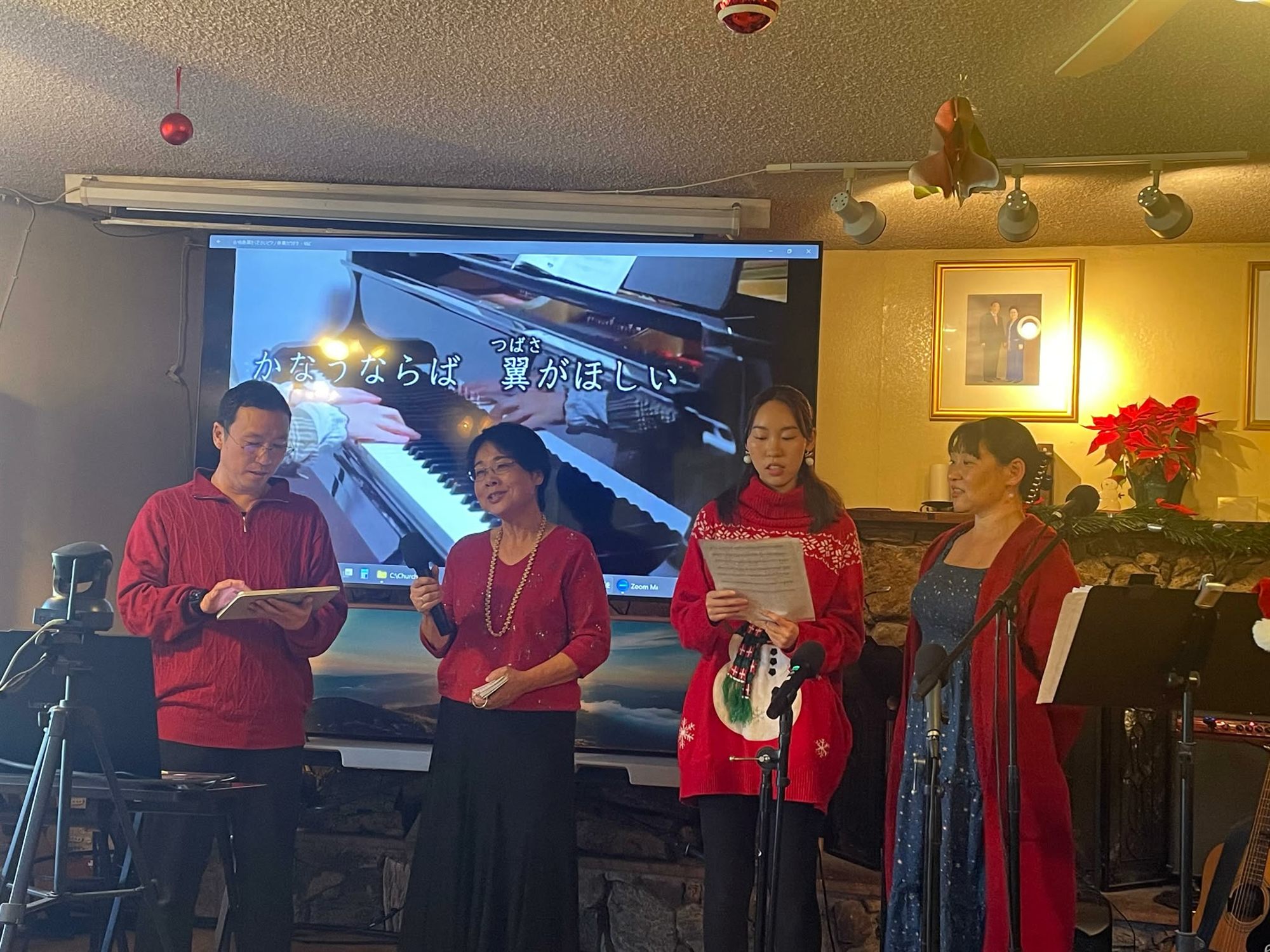 Four church members singing at the front of the sanctuary during a Christmas service