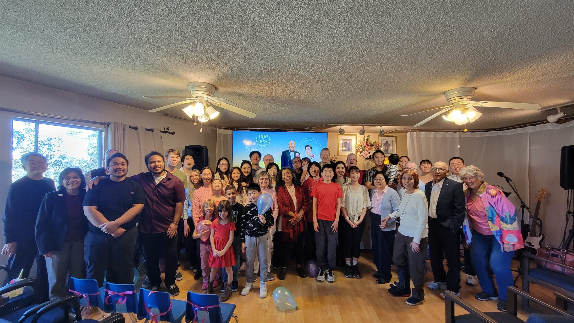The whole congregation together for a group photo after Sunday service, with children holding balloons