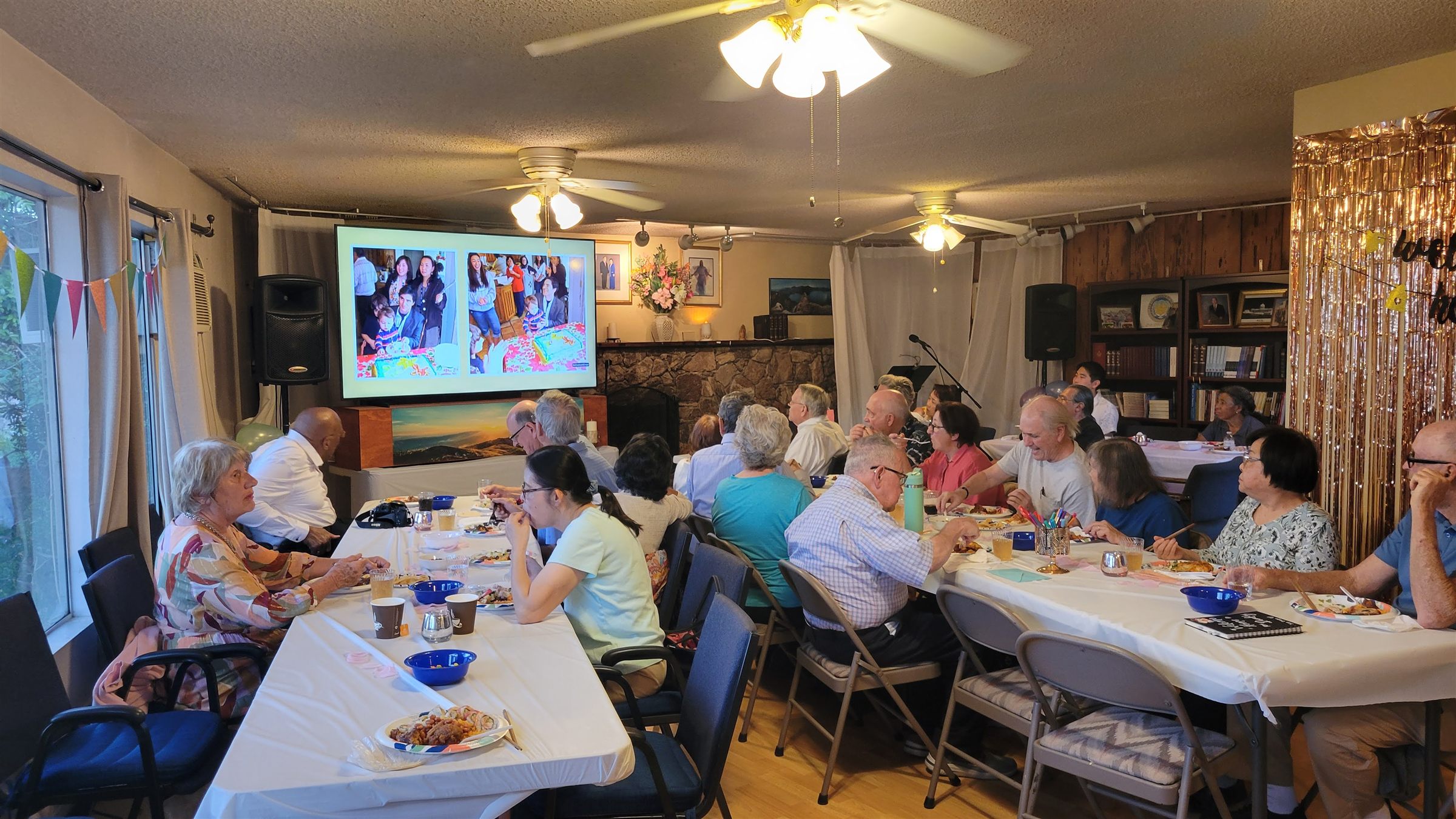 Church members talking over dinner at long tables in the fellowship hall