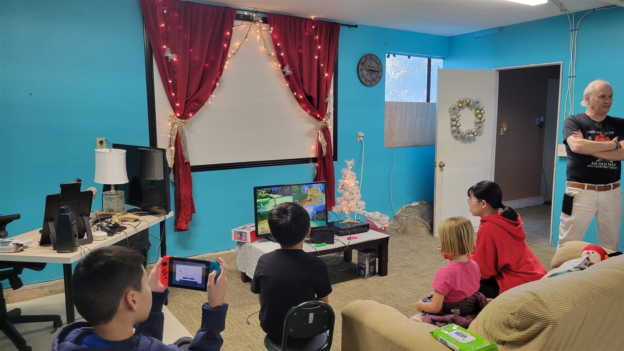 Children playing video games together in the decorated youth room